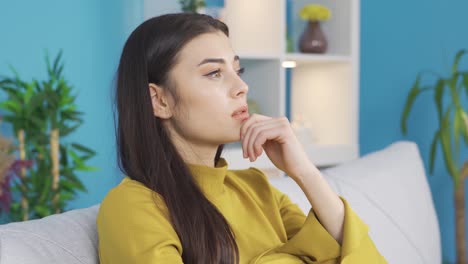 worried young woman thinking with hand on chin, thinking she made wrong decision.