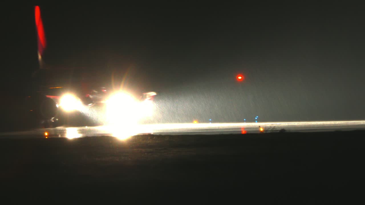 비오는 밤에 공항을 비행하는 비행기