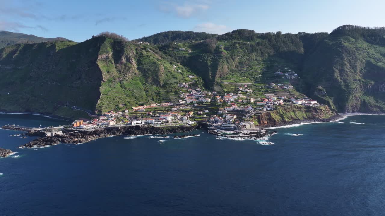 Porto Moniz seaside town and Mole Island on rugged Madeira north coast, aerial