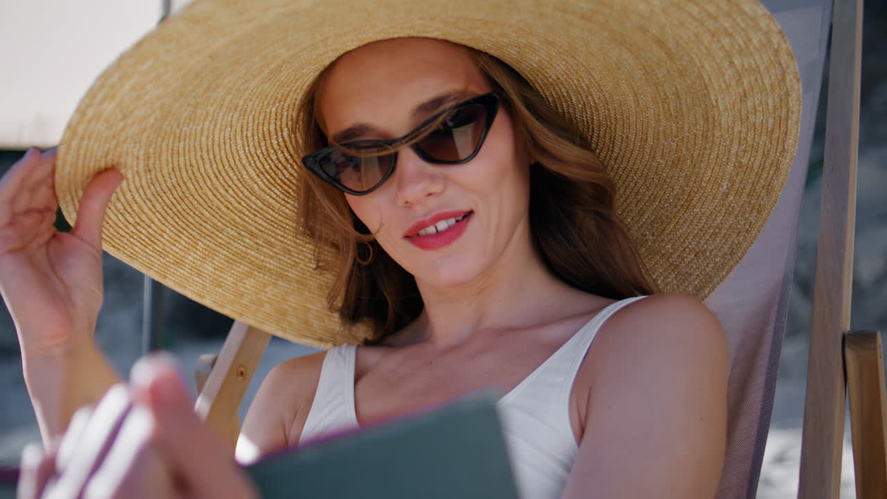 Portrait girl reading coast enjoying summer sea vacation. Woman holding book