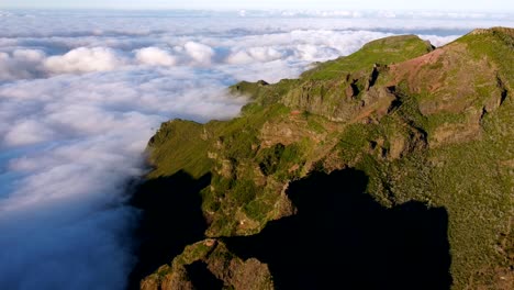 flying above the clouds around the mountain peaks on madeira island