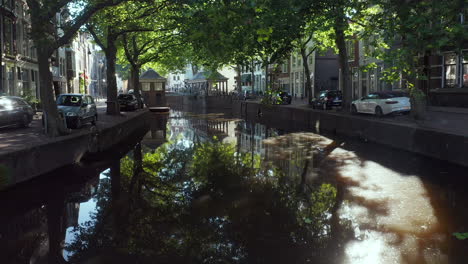 flying towards the historical fish market and placid canal between lage gouwe and hoge gouwe in gouda center, south holland, netherlands