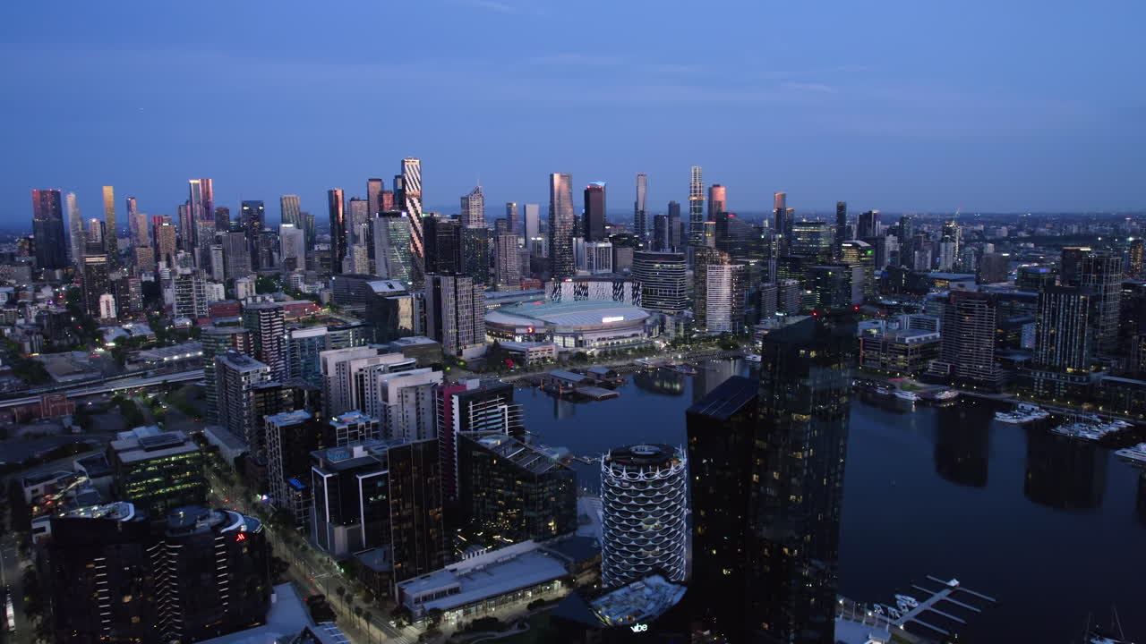 Drone shot over luxury apartments in Docklands, toward Melbourne skyline