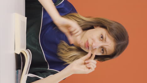 Vertical-video-of-The-young-woman-making-the-small-sign-with-her-hand.