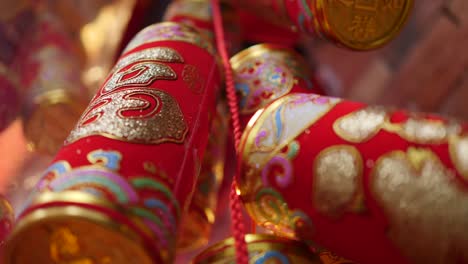 stunning close-up of traditional chinese new year red and gold firecrackers, intricately designed with golden patterns, celebrating culture under warm, festive lighting