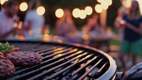 close-up of a grill with burgers, blurred people in the background enjoying a party