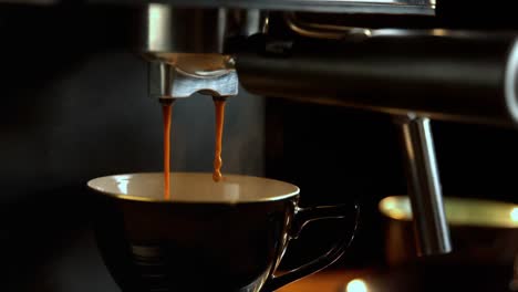 fresh coffee drops falling to coffee cup from coffee machine 4k