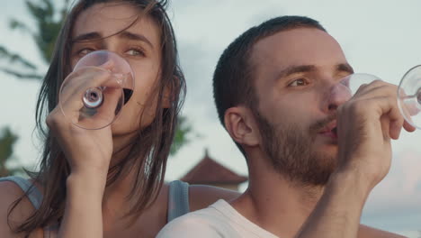 man and woman drinking wine outdoors