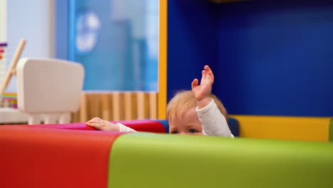 funny little child plays in comfortable playpen at home