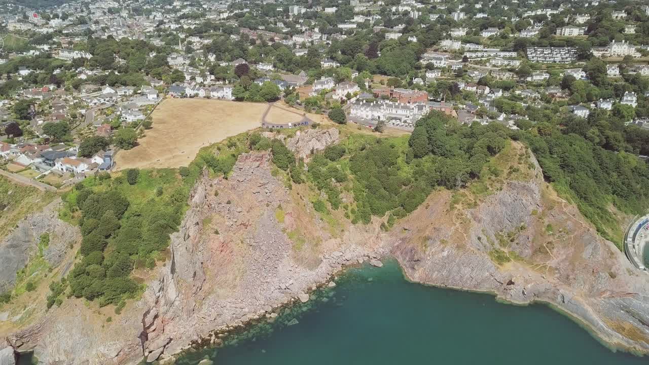 Aerial View of Coastal Town with Cliffs and Sea
