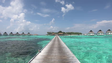 walking with bungalow in ocean sea at maldives