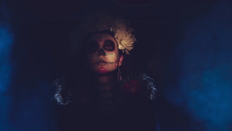 woman with mexican skull halloween makeup on face.