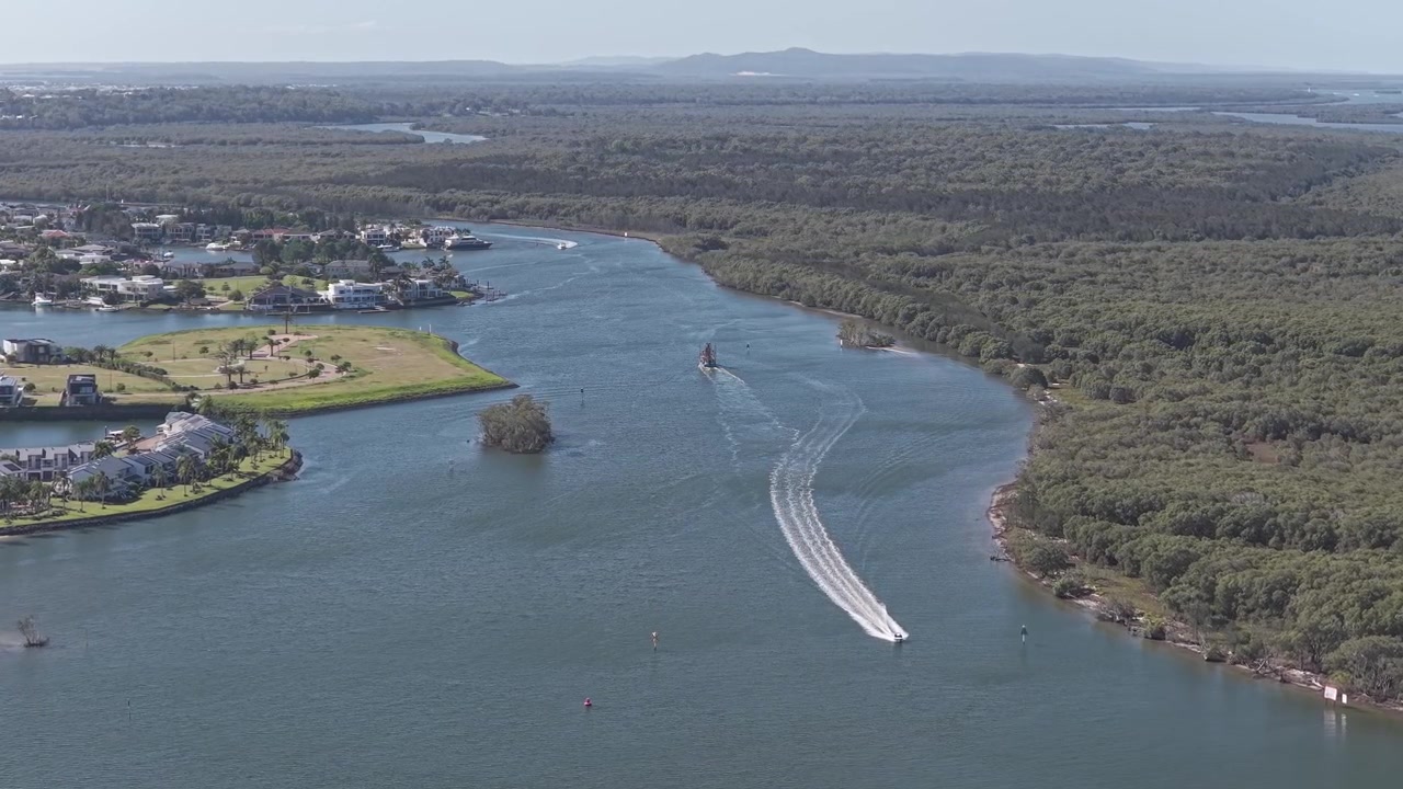 Sungai Coomera di sepanjang pinggiran kota pesisir Paradise Point, Kota Gold Coast, Queensland, Australia. Rekaman drone udara.