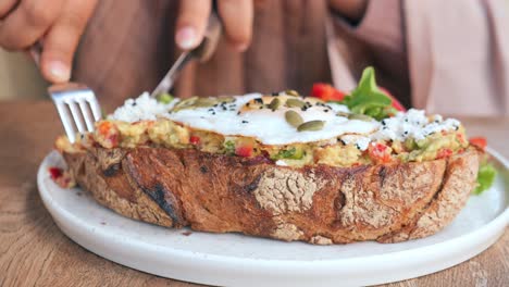 person eating avocado toast