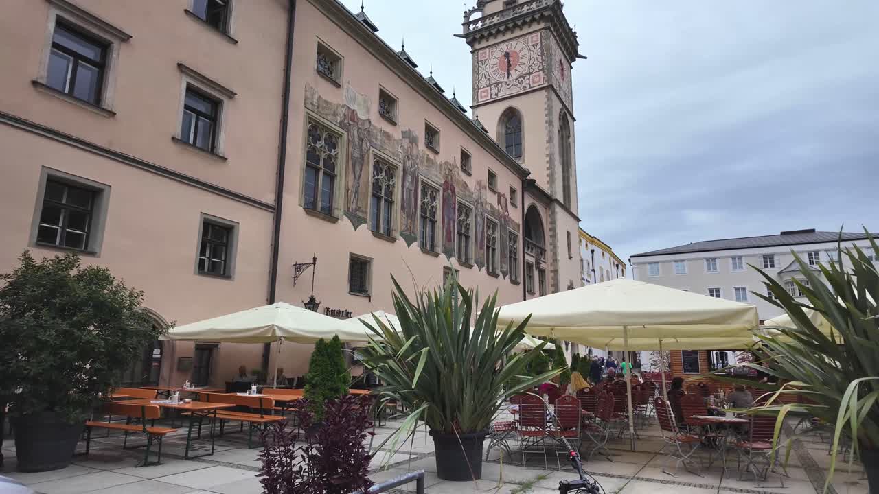 Passau, town hall with wedding party and restaurant benches on public square