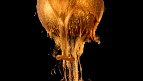 golden shine paint slowly flows from the ball