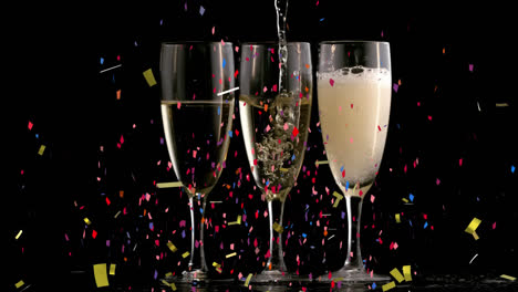 Animation-of-multi-coloured-confetti-falling-against-three-champagne-flutes