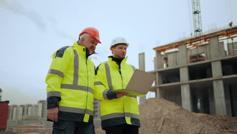 civil engineers are inspecting new object in building area of modern residential complex