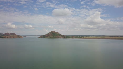 Slow-dolly-shot-revealing-a-remote-island-surrounded-by-water