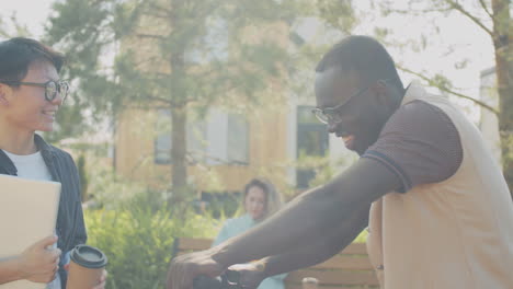 Black Man and Asian Woman Chatting on Street
