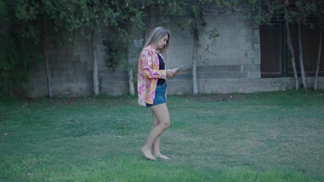 woman walking in a garden with a tablet