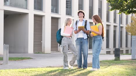 Cheerful young university students using tablet on campus