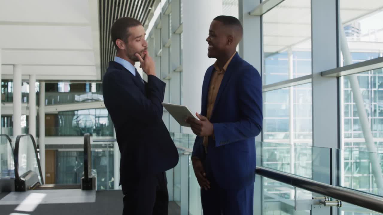 Young businessmen using tablet in a modern office