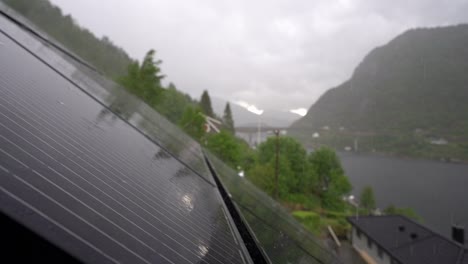 Steady-rain-falling-on-solar-panels-installed-on-roof-of-residential-home