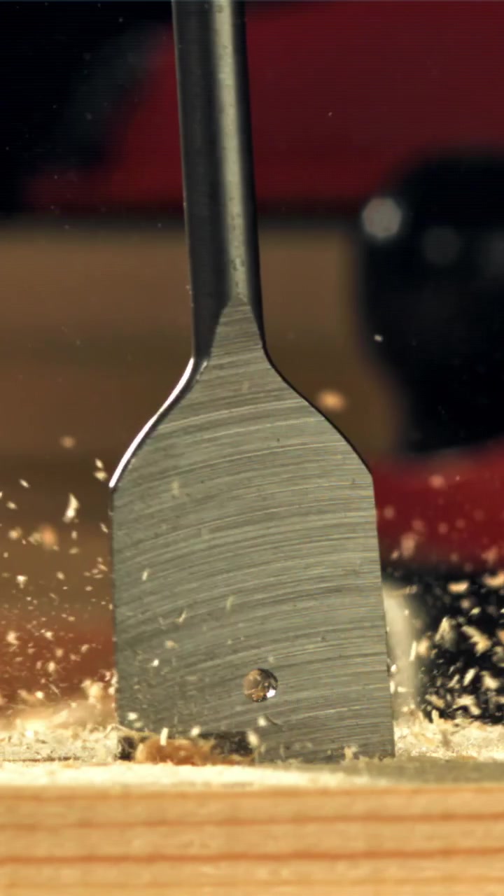 Spade Drill Bit Making a Hole in Wood in Slow Motion