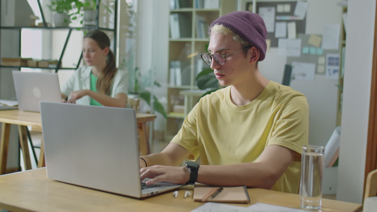 Gen Z Man Using Laptop at Workplace in Office