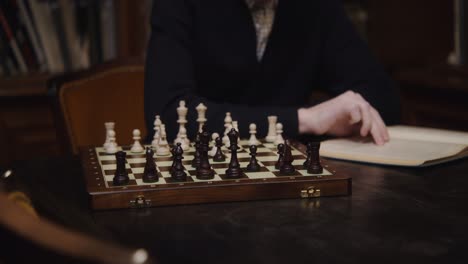 man playing chess in a library