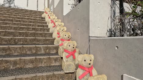 rows of teddy bears sitting on stone stairs