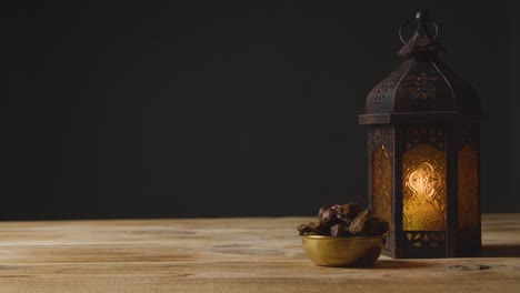 tracking shot of hand taking a glass of water and date on a table for ramadan