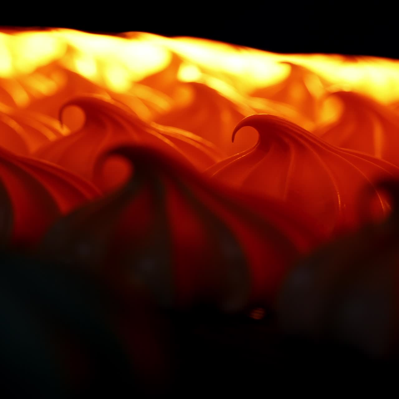 White marshmallows lit in orange in a drier machine. Manufacturing sweet desserts at present day factory. Close up. Blurred background