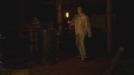 person performing with fire in a dark place