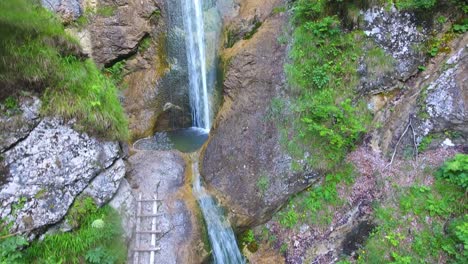 repov slap waterfall meditative natural cascade between stone valley aerial drone in slovenian travel and tourism destination