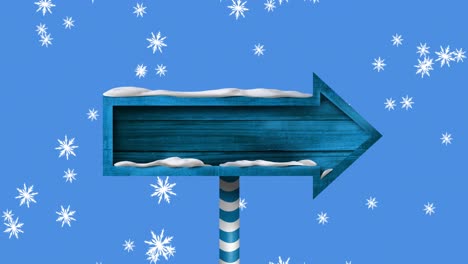 Digital-animation-of-snowflakes-falling-over-blue-wooden-arrow-shaped-sign-post