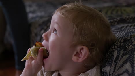 side view of caucasian baby eating at home