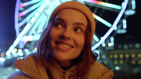 young woman posing for camera outdoor. girl smiling on illuminated background.