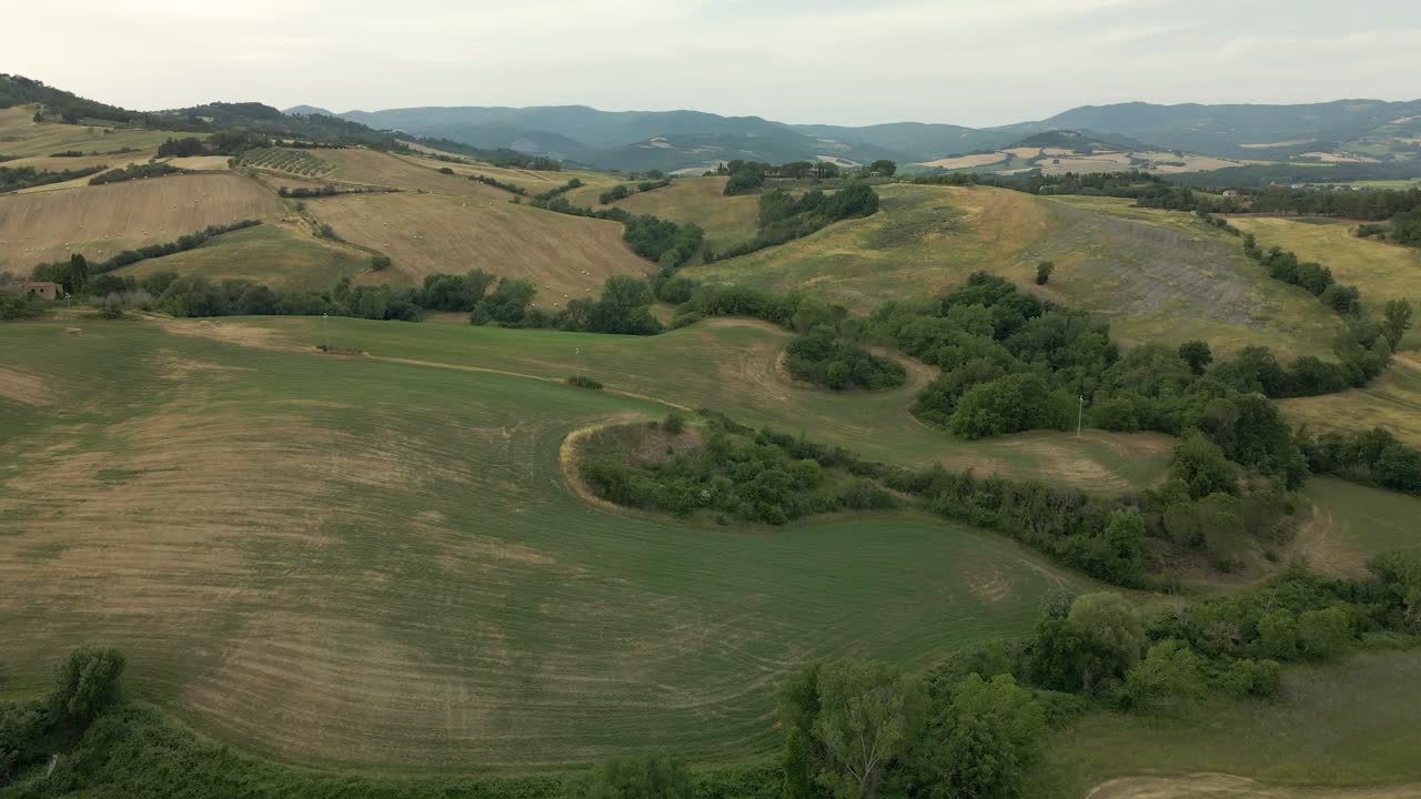 Aerial images of Tuscany in Italy cultivated fields summer, Crane view dry cultivated fields