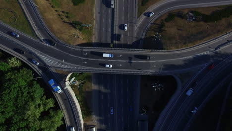 Top-view-car-moving-on-freeway-overpass.-Car-traffic-on-highway-intersection