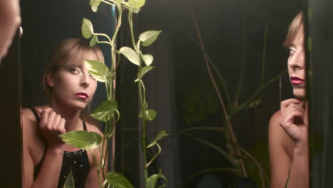 woman looking in mirror with makeup
