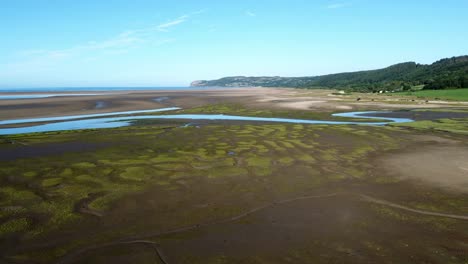 aerial view rising over traeth coch pentraeth welsh rural marshland scenic farming countryside at sunset