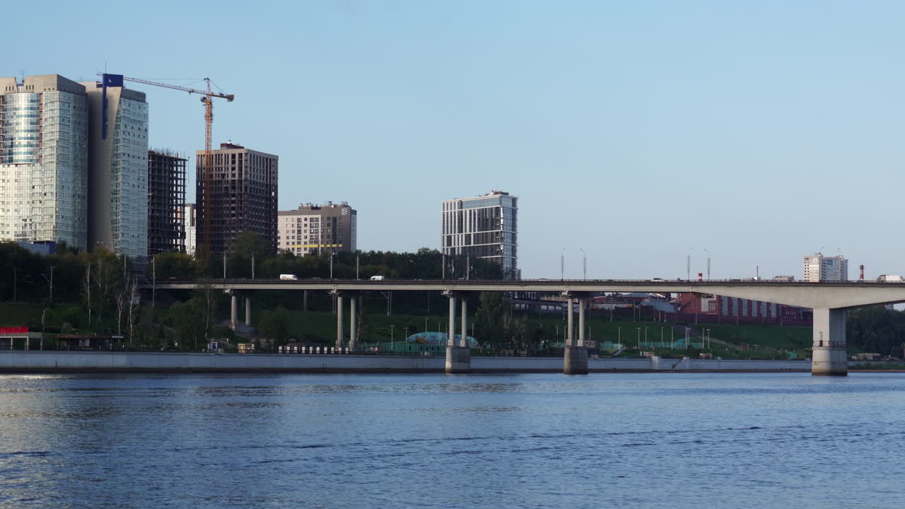City River View with Bridge, Modern Buildings, and Construction Crane