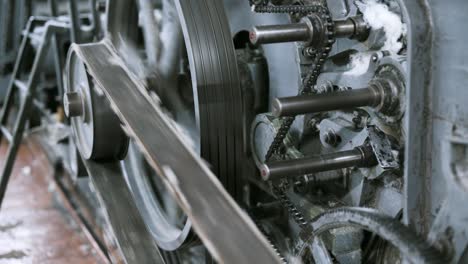 old vintage loom, many rotating wheels