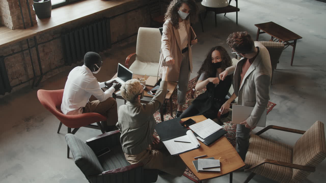 Top-View of Coworkers in Face Masks Arriving at Meeting
