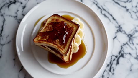 delicious stacked french toast with banana and bacon