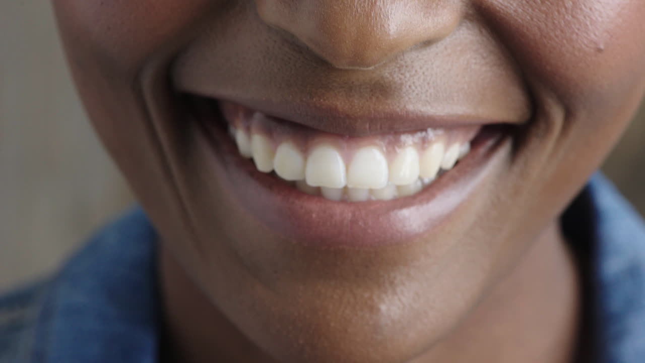 close up african american woman mouth smiling lips showing healthy teeth dental health concept