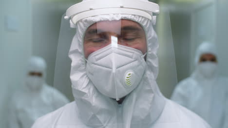 portrait of male doctor in protective uniform in clinic