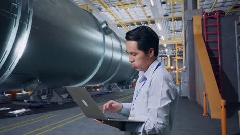 engineer working on a project in a large industrial facility